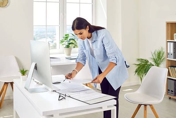 istock Young business woman accountant working on pc computer with financial documents at office. 2236333312