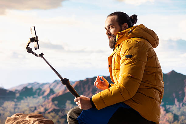 istock Hiker influencer live streaming from a breathtaking mountain peak 2236339553