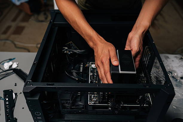 istock Close-up cropped shot of technician installing CPU water cooler into desktop computer case, showcasing process of computer maintenance and upgrade. 2236339905
