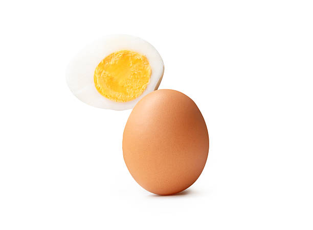 istock Front view of raw brown chicken eggs and cooked or boiled chicken egg with egg yolk in half in stack isolated on white background with clipping path 2236340277