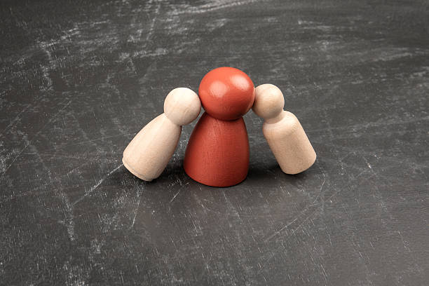 istock Concept of gossip pressure or manipulation using wooden figures on dark background 2236340287