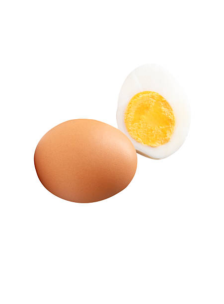 istock Front view of raw brown chicken eggs and cooked or boiled chicken egg with egg yolk in half in stack isolated on white background with clipping path 2236341315