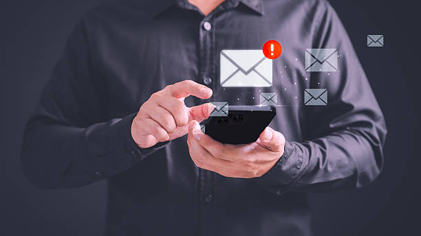 istock Person using a smartphone receives a new email notification, highlighting the email and internet communication, data, digital marketing, e-mail icon technology and online networking concept. 2236341420