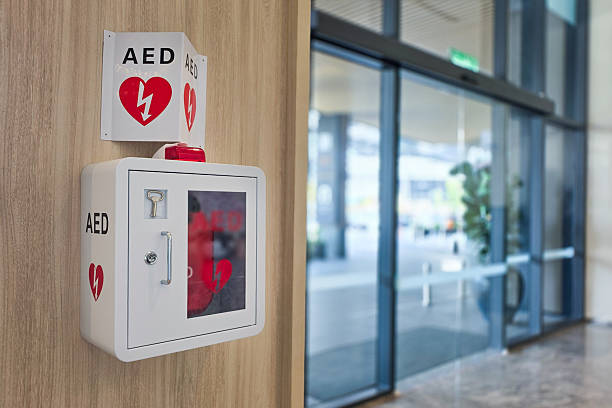 AED or Automated External Defibrillator installed on wall in hotel lobby as first aid in heart attack emergency situation.