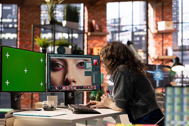 istock Freelance designer works on photo editing next to chroma key screen 2236343934