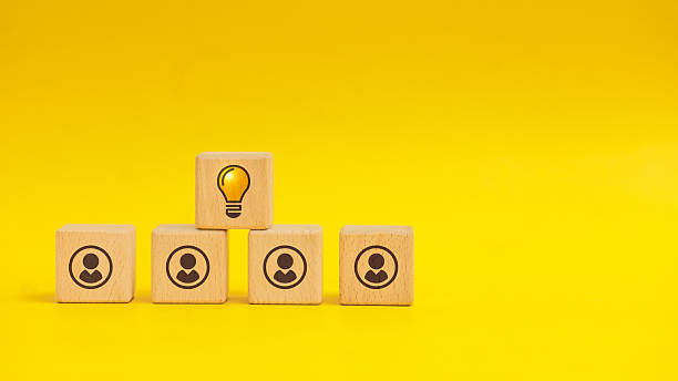 istock Creative Idea Light Bulb Above People Wooden Blocks, Yellow Background 2236346341