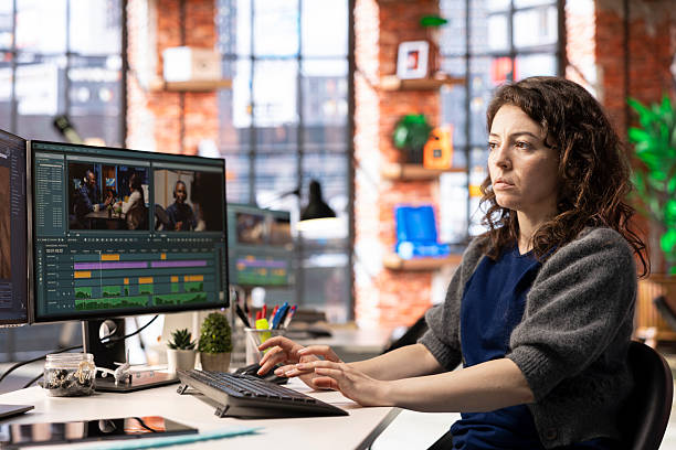 istock Woman video creator working on editing a movie montage project 2236346955