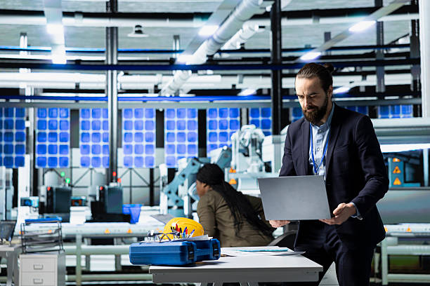 istock General director in formal clothes evaluating factory workflow 2236348062