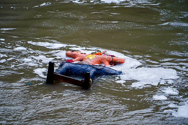 Hindu devotees immerse an idol of Lord Vishwakarma in the Bagmati River on the second day of worship, in Kathmandu, Nepal, on September 18, 2025.