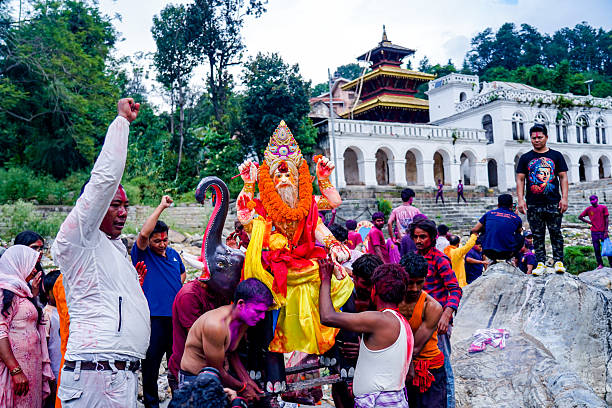 Hindu devotees immerse an idol of Lord Vishwakarma in the Bagmati River on the second day of worship, in Kathmandu, Nepal, on September 18, 2025.