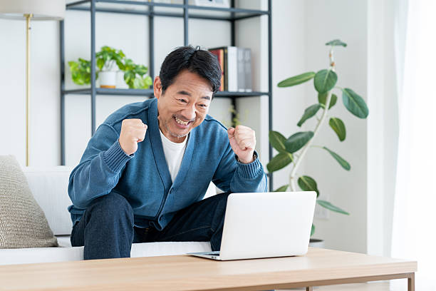 istock Middle-aged man using a computer in the living room 2236351287