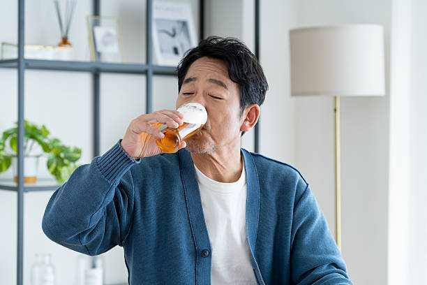 istock Middle-aged man drinking beer at home 2236351564