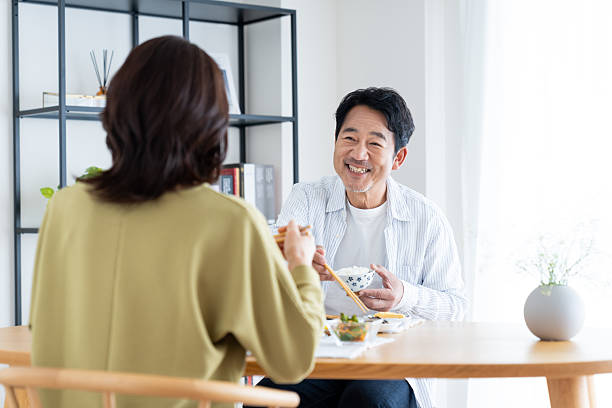 istock Middle-aged couple having breakfast at home 2236352520