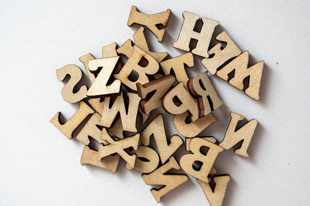 istock Wooden Alphabet Letters in a Random Pile on a Light Background 2236353274