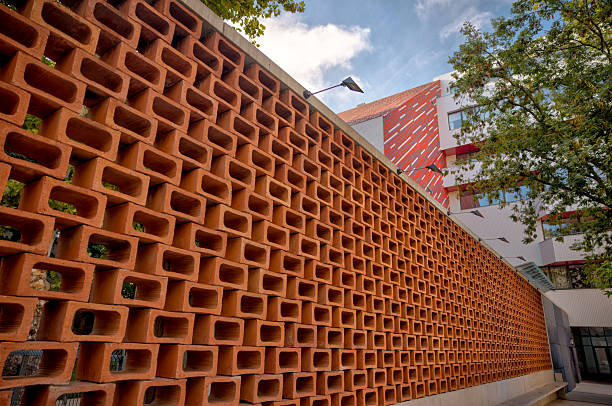 Bratislava, Slovakia – July 24, 2025: A striking terracotta brick screen wall showcases mid-century modern design outside the Slovak Radio Building. The repeating geometric pattern creates depth and shadow play, highlighting the era’s architectural boldness.