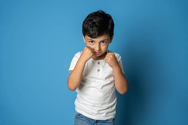 istock Playful Little Boy Posing Like a Fighter with Serious Expression 2236358132
