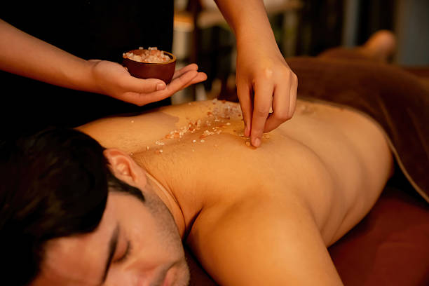 istock Man customer having exfoliation treatment in luxury spa. Quiescent 2236358658