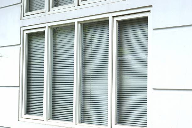 istock Window with closed blinds in a white wall, representing privacy and modern architecture 2236359574