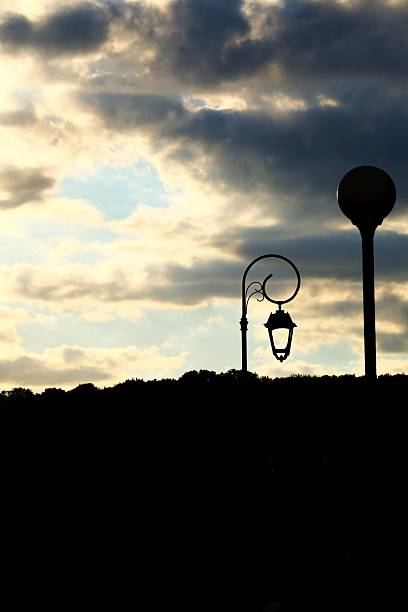 istock Silhouetted Street Lamps Against a Dramatic cloudy Sky 2236359899