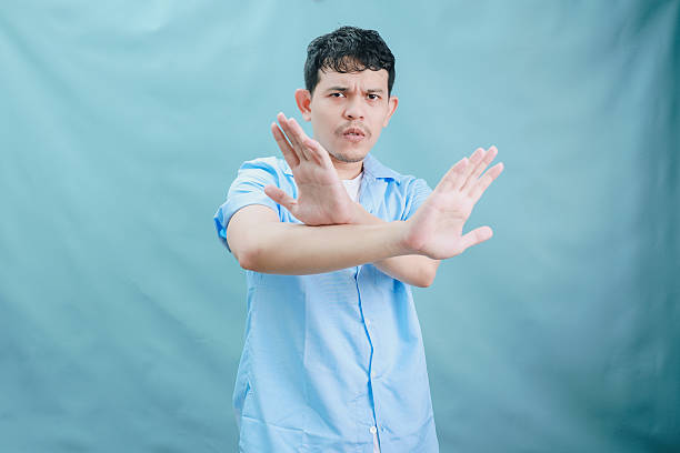 istock A Young Man in a Light Blue Shirt Demonstrates a Expressive Gesture Against a Soft Background 2236360104
