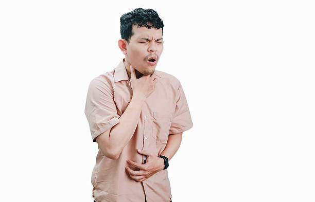 istock Man experiencing discomfort, holding throat and stomach. 2236361323