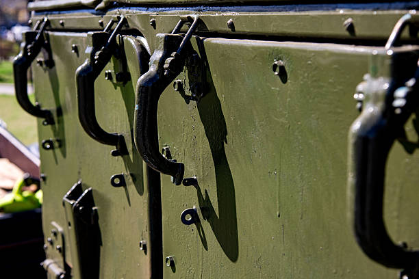 istock Military supply boxes stored outdoors during a sunny day, showcasing sturdy handles and weathered surfaces in a military base setting 2236364565