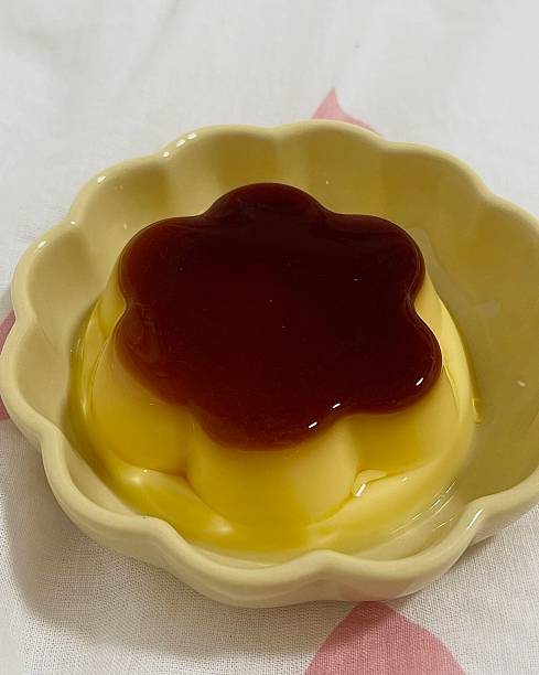 istock Soft and silky mini pudding served in a petite cup, with a melt-in-your-mouth texture and a delicate sweetness. A charming bite-sized treat perfect for any time of the day. 2236367083