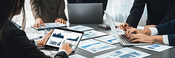istock Analyst team utilizing BI data on tablet for business marketing. Prodigy 2236368637