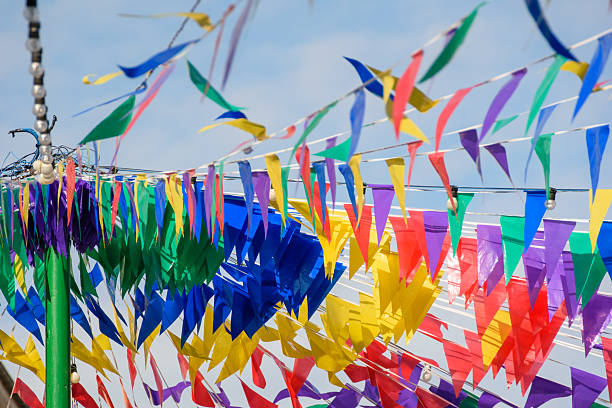 istock A string of multicolored party flags against a blue sky. 2236370501
