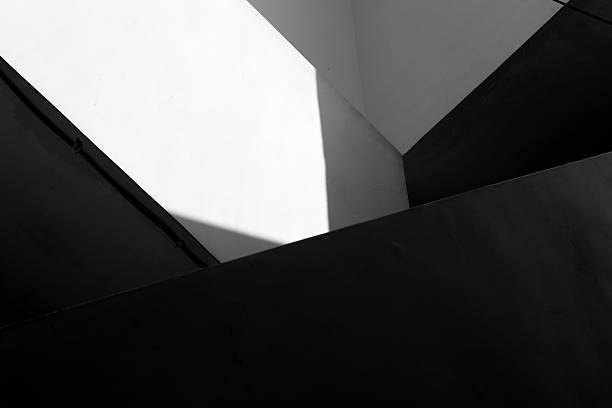 An abstract, blurred image showcasing Hong Kong's architectures, with a radial blur effect. The monochrome shot captures light and shadow.