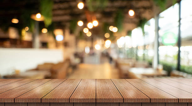 istock Empty wooden table top with lights bokeh on blur restaurant background. 2236374790