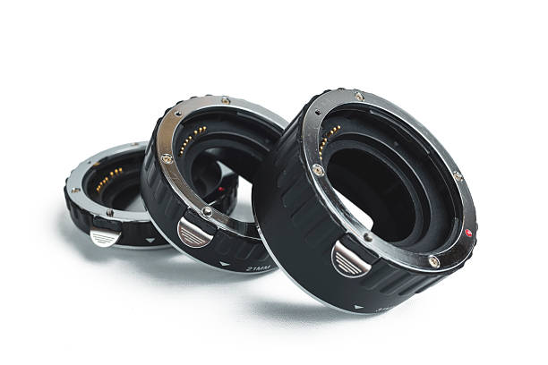 A set of three black and silver macro extension tubes for a camera, isolated on a clean white background.
