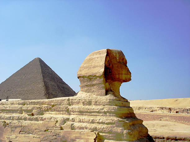 The famous Sphinx with the Great Pyramid of Cheops as background.