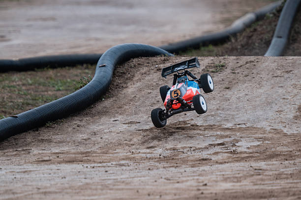 istock Radio-controlled car jumping on a dirt track during a race 2236380665