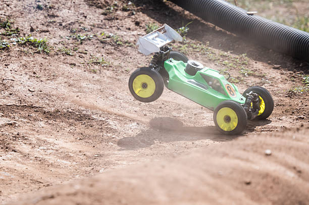 istock Radio-controlled car jumping on dirt track in racing competition 2236380710