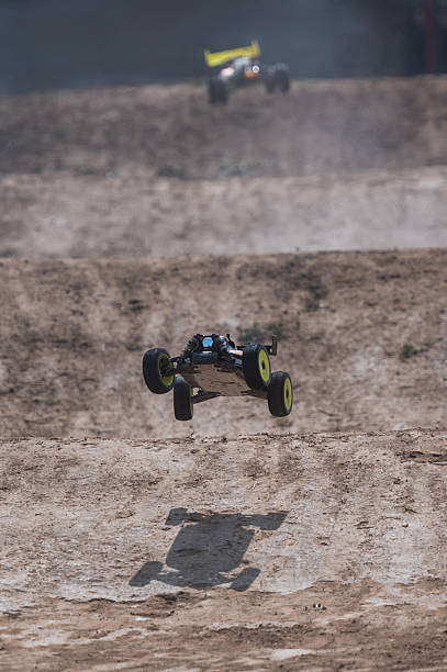 istock Radio-controlled car jumping on dirt track during race 2236380789