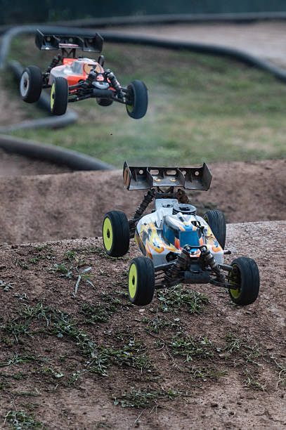 istock Radio-controlled cars jumping on dirt track 2236380949