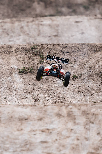 istock Radio-controlled car jumping on dirt track 2236381033