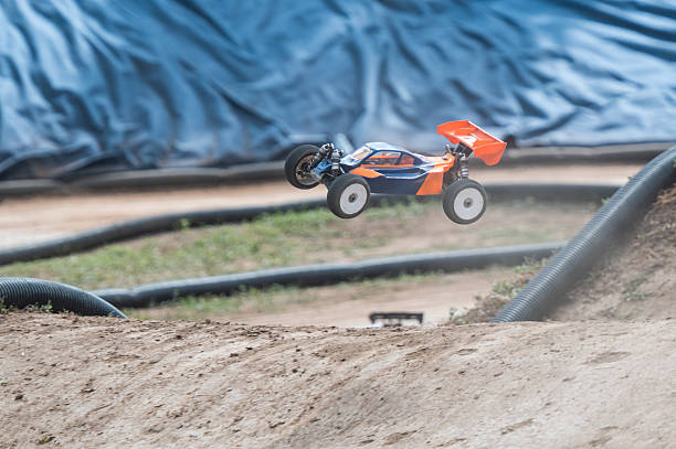 istock Radio-controlled car performing a spectacular jump on a dirt track 2236381067
