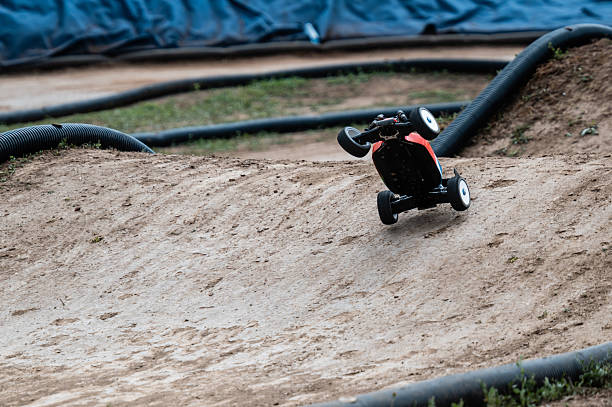 istock Radio-controlled car performing a jump on a dirt track 2236381074