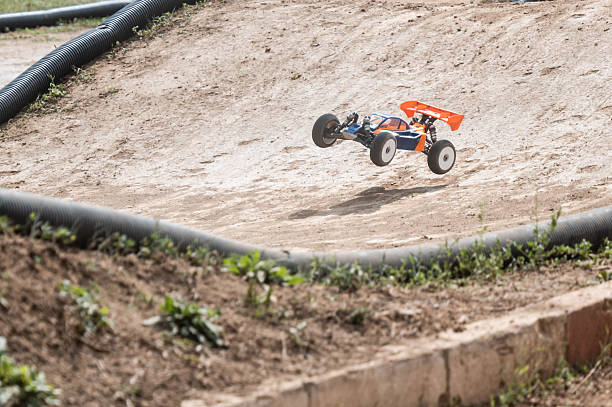 istock Radio-controlled car jumping on dirt track in racing competition 2236381097