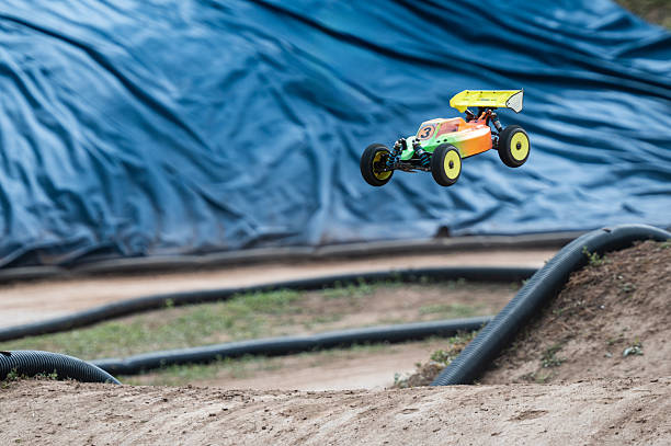 istock Radio-controlled car jumping on dirt track 2236381108
