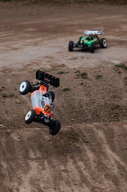 istock Radio-controlled car performing a jump on a dirt track 2236381120