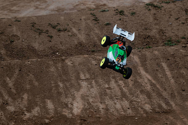 istock Radio-controlled car jumping on dirt track 2236381125