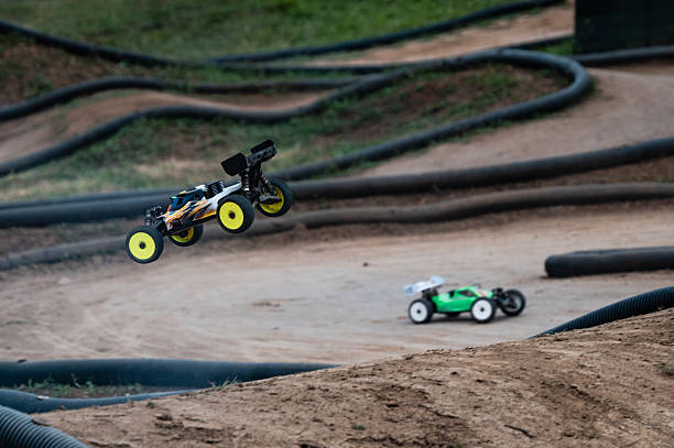 istock Radio-controlled car jumping on a dirt track during a race competition 2236381164