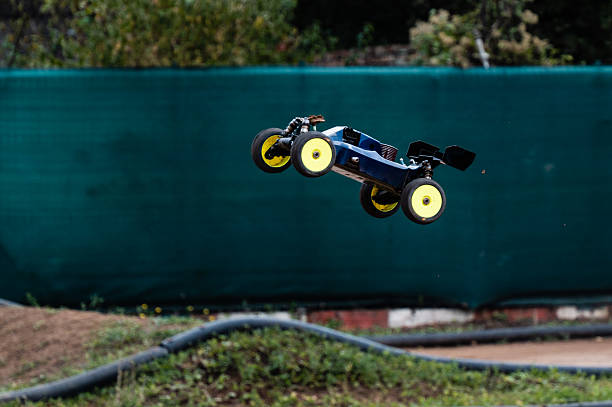 istock Radio-controlled car performing a jump on a dirt track 2236381198