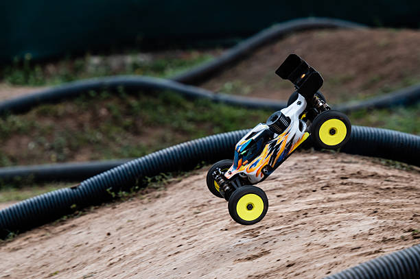 istock Radio-controlled buggy jumping on a dirt track during a race 2236381200
