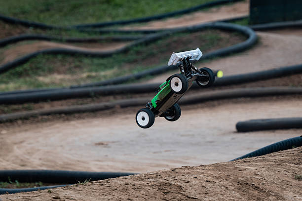 istock Radio-controlled car performing a jump on a dirt track 2236381204