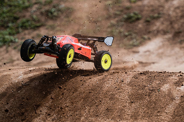 istock Radio-controlled car jumping on dirt track, raising dust 2236381236