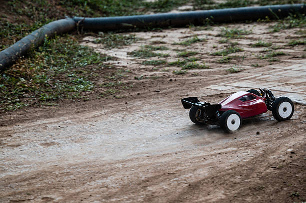 istock Radio-controlled car drifting on dirt track, raising dust 2236381237